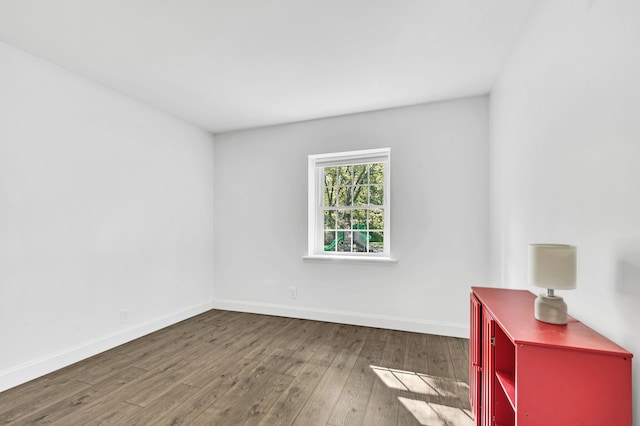 spare room with dark wood-type flooring