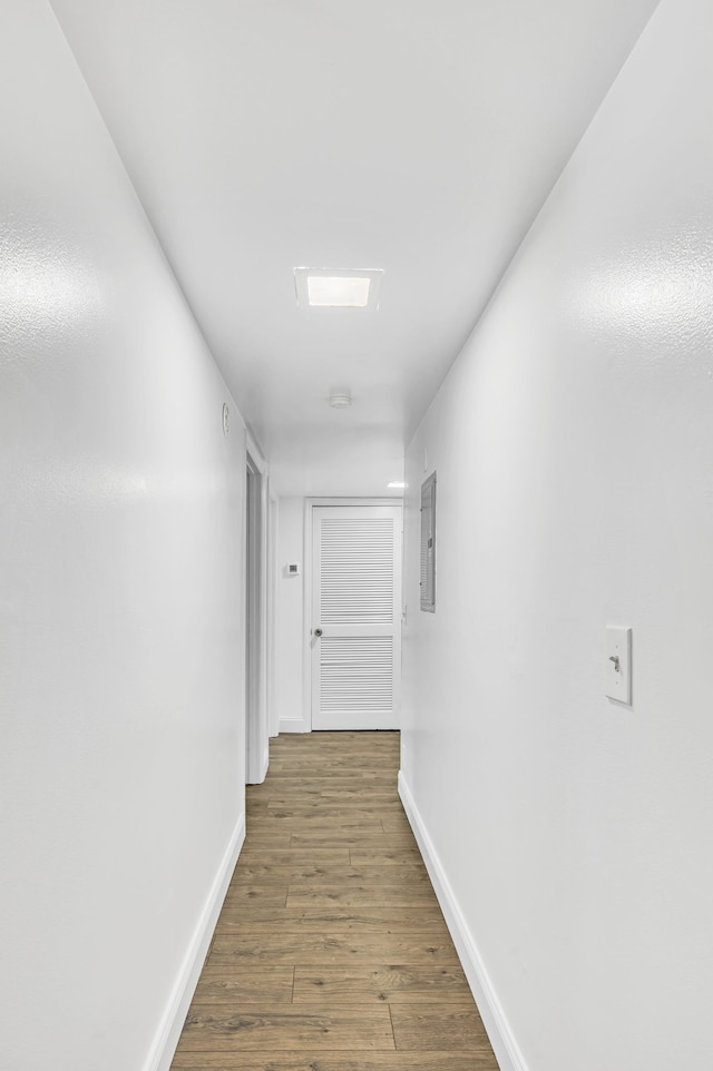 hall with electric panel and dark hardwood / wood-style floors