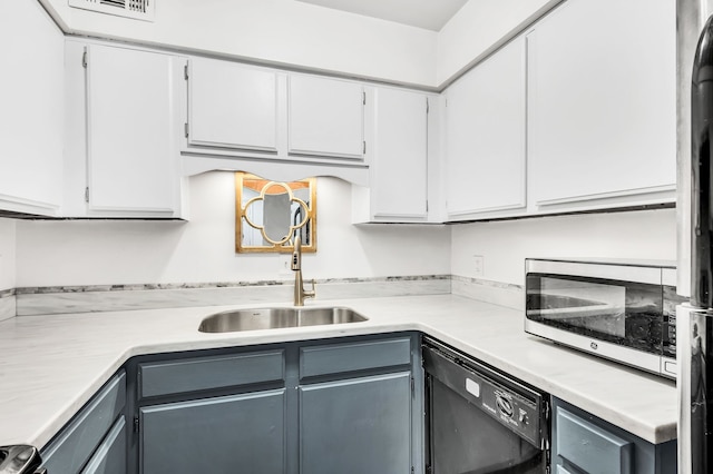 kitchen with white cabinets, black dishwasher, and sink