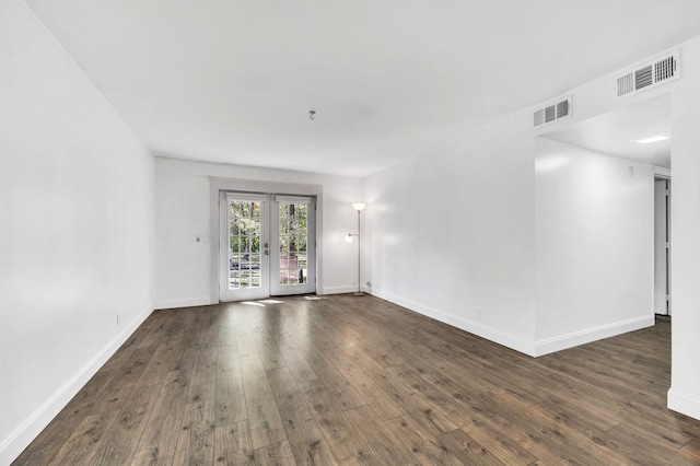 spare room with french doors and dark wood-type flooring