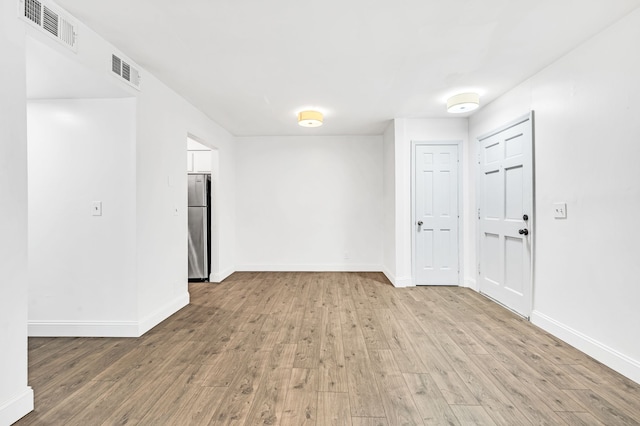 unfurnished room with light hardwood / wood-style flooring