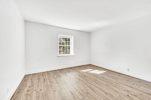 empty room with light hardwood / wood-style floors