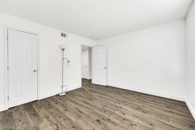 unfurnished bedroom with dark hardwood / wood-style floors