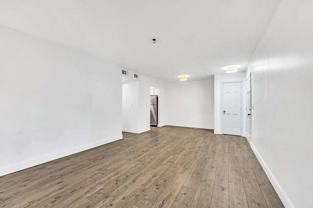 spare room featuring hardwood / wood-style floors