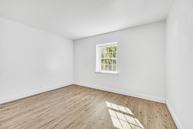 spare room featuring light hardwood / wood-style flooring