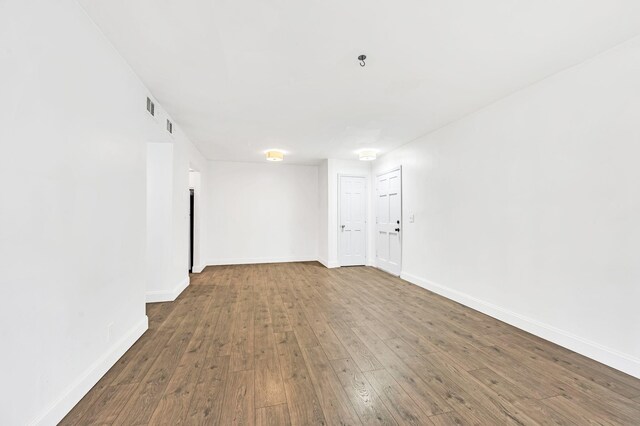 spare room featuring dark hardwood / wood-style flooring