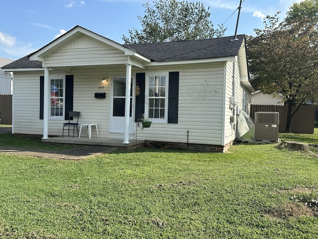bungalow with fence, a front yard, a porch, and roof with shingles