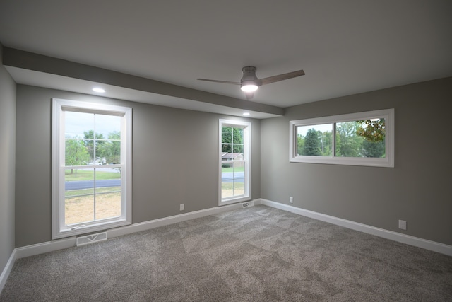 carpeted empty room featuring ceiling fan