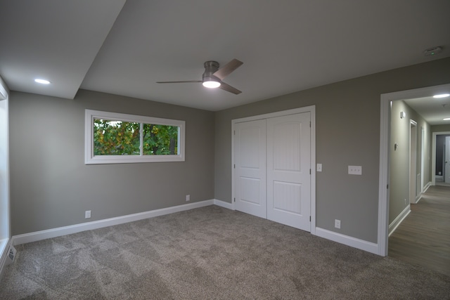 unfurnished bedroom with ceiling fan, a closet, and carpet