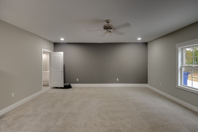 unfurnished room with ceiling fan and light colored carpet