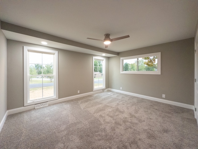 unfurnished room featuring ceiling fan, carpet flooring, and a healthy amount of sunlight