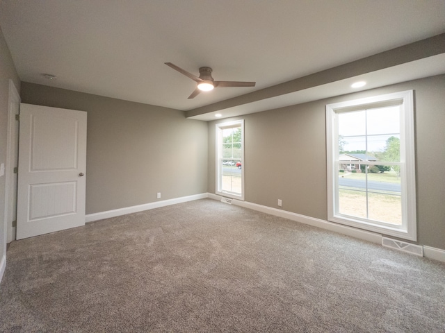 spare room featuring carpet floors and ceiling fan