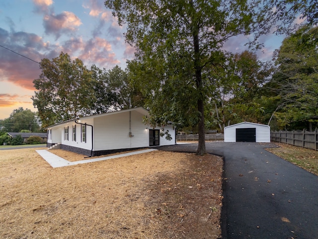 view of front of property with an outdoor structure and a garage