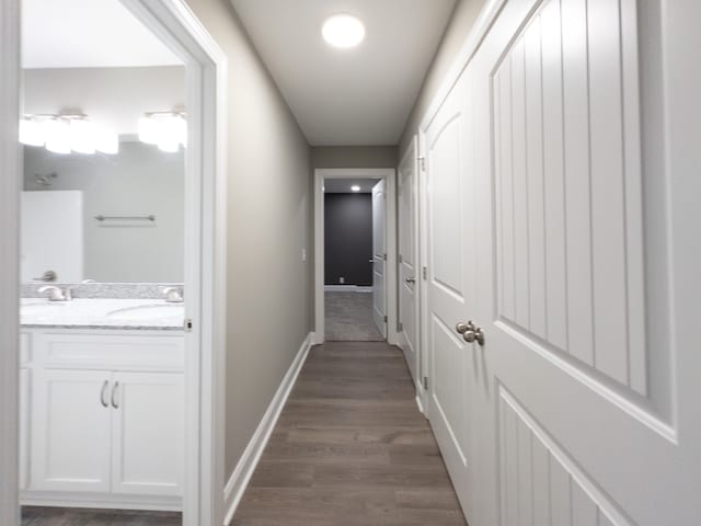 corridor featuring dark hardwood / wood-style floors and sink