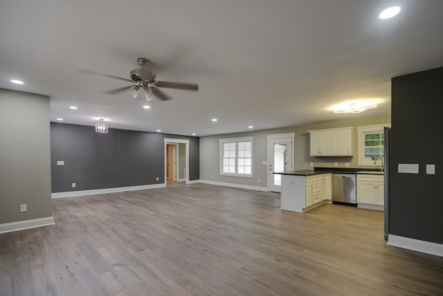 kitchen with ceiling fan, light wood-type flooring, white cabinetry, and stainless steel dishwasher