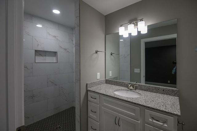 bathroom featuring vanity and tiled shower