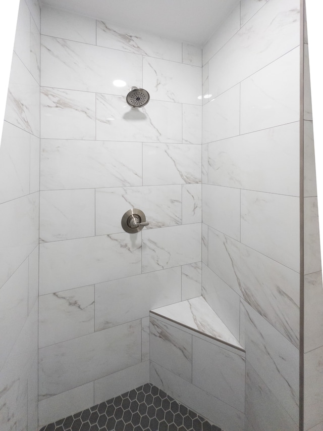 bathroom with tiled shower