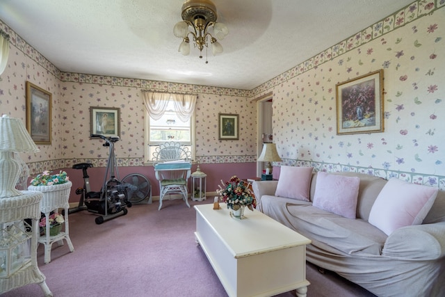 carpeted living room featuring ceiling fan and a textured ceiling