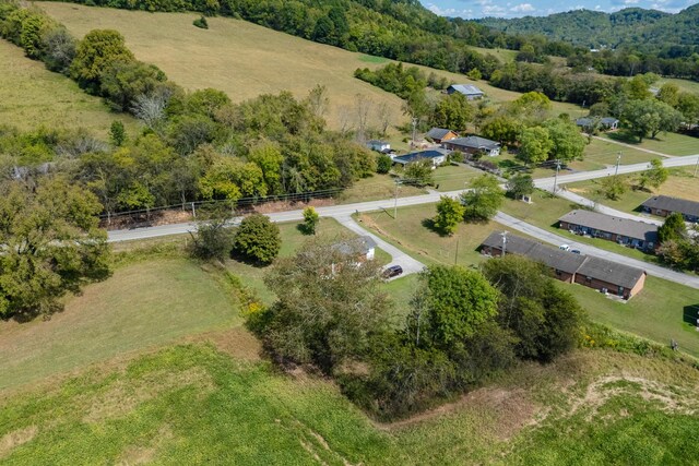 birds eye view of property with a rural view