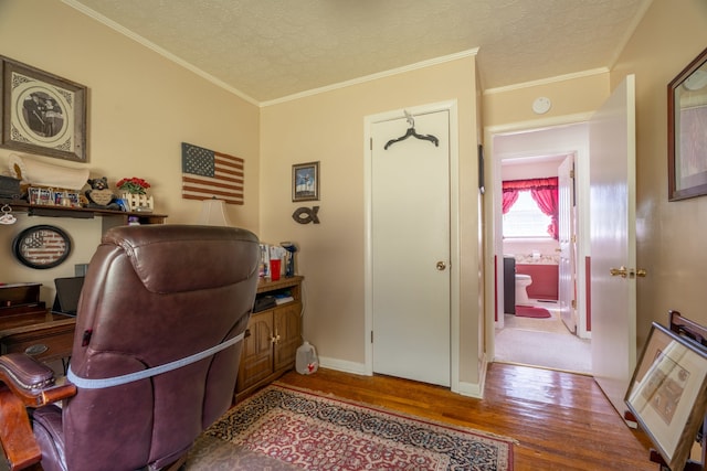 home office with ornamental molding, a textured ceiling, and hardwood / wood-style floors