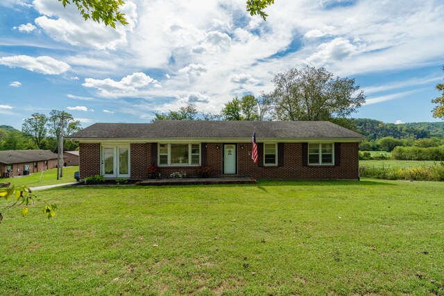 ranch-style home with a front lawn