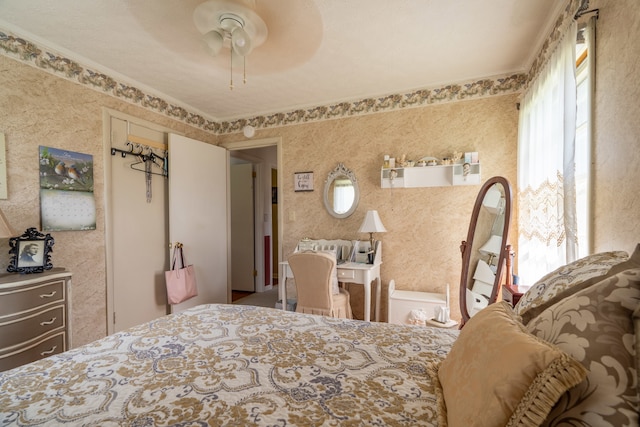 bedroom featuring ceiling fan and ornamental molding