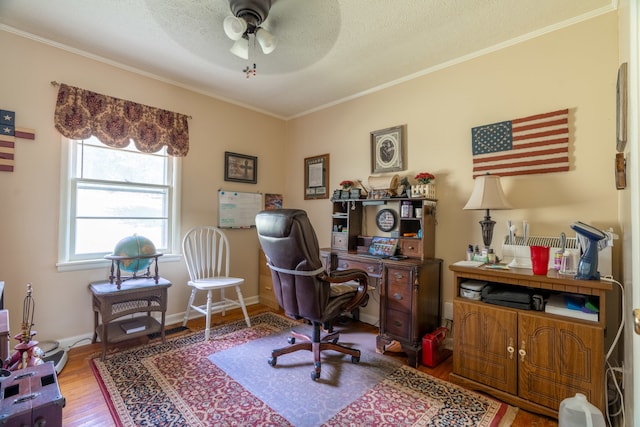 office space featuring ceiling fan, a textured ceiling, ornamental molding, and wood-type flooring