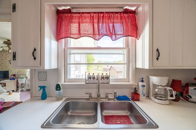 kitchen featuring sink and white cabinets