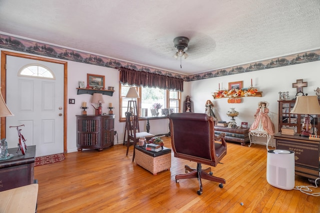 office with ceiling fan, hardwood / wood-style flooring, and a textured ceiling