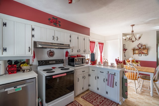 kitchen with white cabinets, hanging light fixtures, kitchen peninsula, appliances with stainless steel finishes, and an inviting chandelier