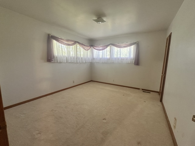 spare room with light colored carpet