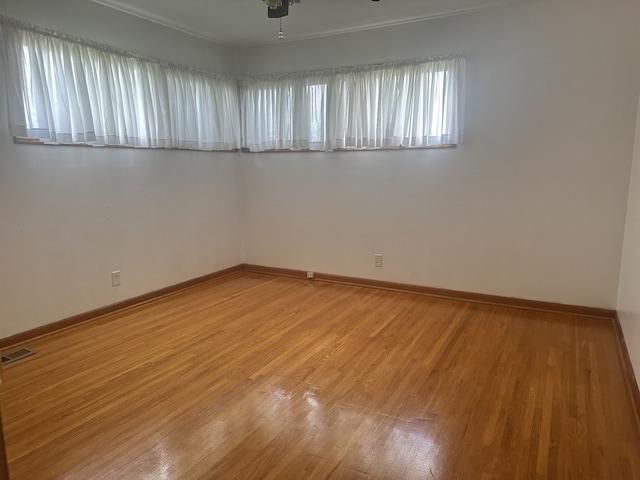 unfurnished room featuring hardwood / wood-style floors and ceiling fan