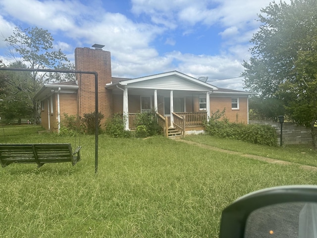 2550 Indian Mound Rd, Woodlawn, TN 37191 - rear view of property with a lawn, a chimney, a porch, and brick siding