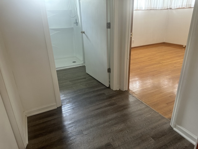 hallway with dark hardwood / wood-style floors