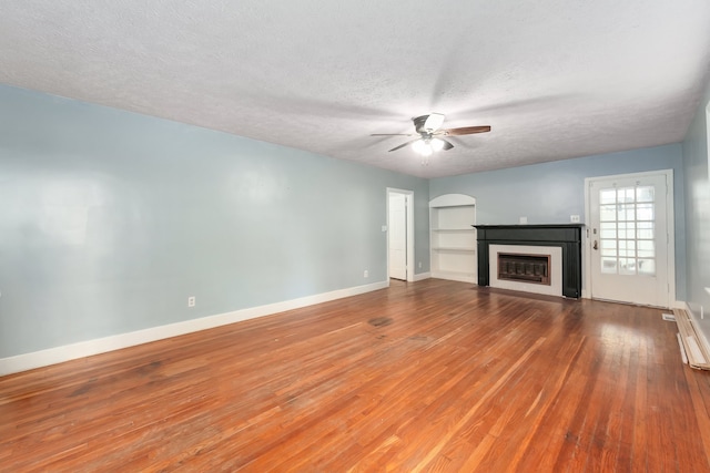 unfurnished living room with a textured ceiling, ceiling fan, and hardwood / wood-style flooring