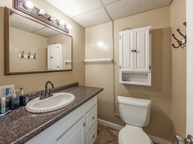 bathroom featuring tile patterned flooring, vanity, and toilet