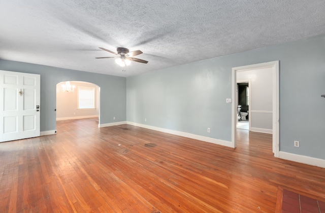 empty room with a textured ceiling, ceiling fan, and hardwood / wood-style flooring