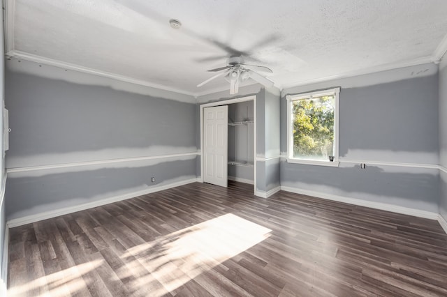 unfurnished bedroom featuring a textured ceiling, ceiling fan, crown molding, and dark hardwood / wood-style flooring