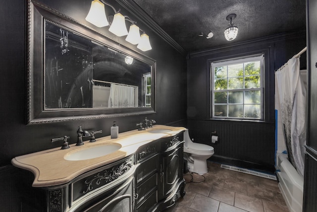 full bathroom with tile patterned flooring, a textured ceiling, ornamental molding, vanity, and toilet