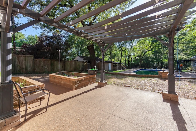 view of patio / terrace featuring a pergola, a fenced in pool, and a shed