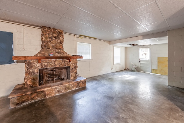 interior space featuring a fireplace and a drop ceiling