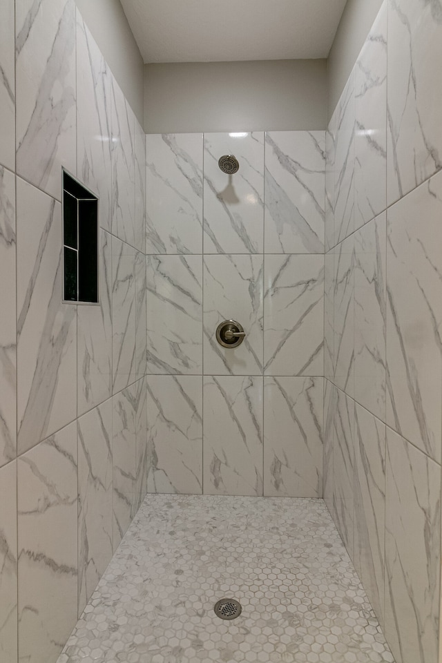 bathroom with a tile shower