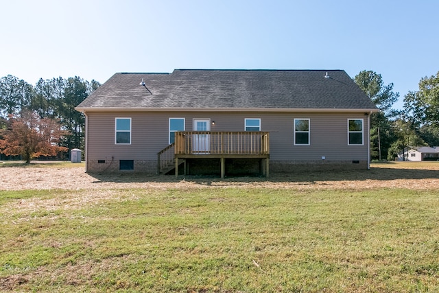 rear view of house featuring a deck and a yard