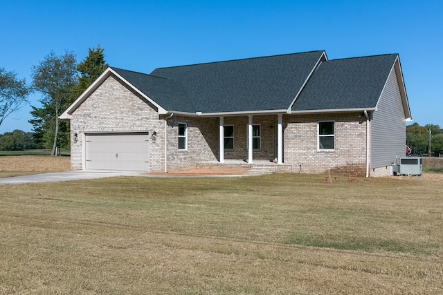 view of front of property with central AC, a front lawn, and a garage