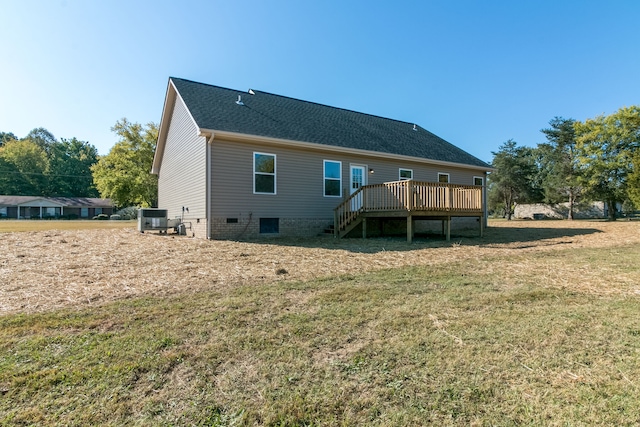 back of house with a lawn, a deck, and central AC