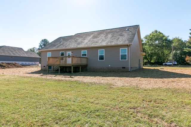 rear view of house featuring a deck and a yard