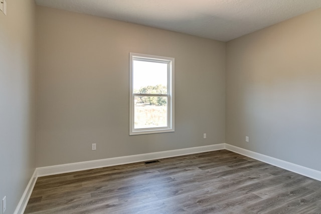 spare room with hardwood / wood-style flooring and a textured ceiling