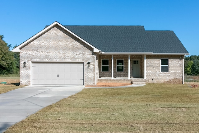 view of front of house featuring a garage, a porch, and a front lawn