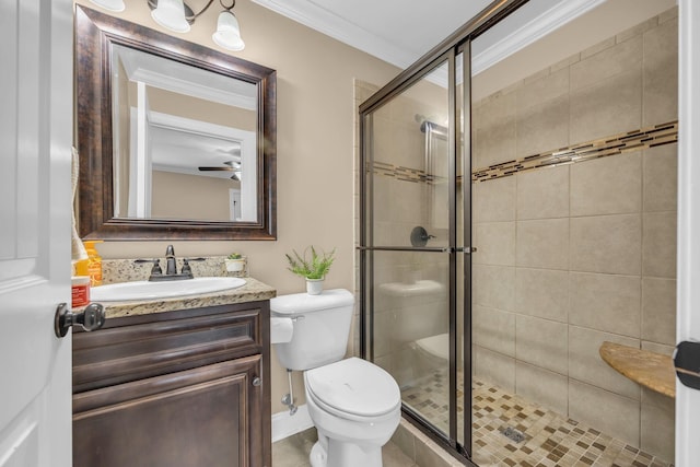 bathroom with vanity, toilet, walk in shower, and ornamental molding