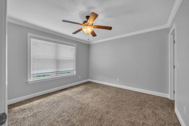 carpeted spare room with ceiling fan and crown molding